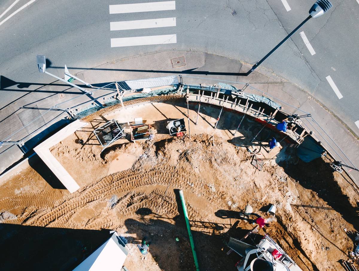 Luftbild einer Baustelle mit Baugrube und geschwungener Schalung in Bergisch Gladbach