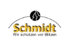 Goldfarbenes "Schmidt"-Logo mit kleinerem Text "Das Spiel ist im Kasten" darunter und einem schwarzen Bogen.