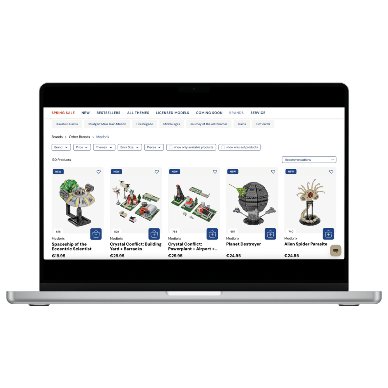 Laptop zeigt Online-Shop für Modbrix-Produkte mit Bestsellern wie Raumschiff, Kristallkonflikt und Planetenzerstörer.