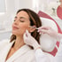 Gloved hand injects medical aesthetics injection into woman's cheek