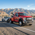 Towing Sandy roadside assistance service helping a driver with a disabled car while a tow operator prepares the vehicle for recovery on the roadside.