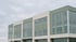 Verglaste Fassade eines Bürogebäudes unter bedecktem Himmel