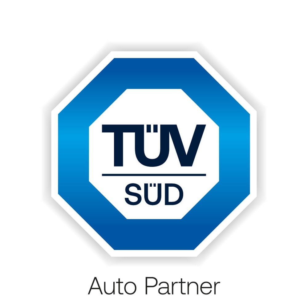 Blaues achteckiges TÜV SÜD Logo mit dem Text Auto Partner auf weißem Hintergrund.