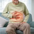 Man holding his stomach, indicating gut pain.