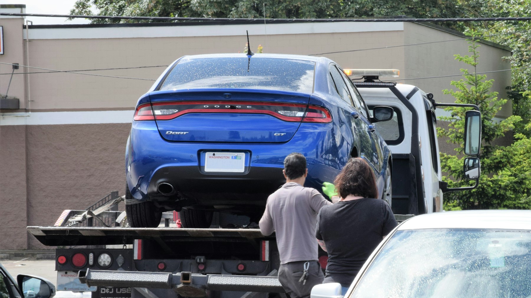 Car being winched onto a flatbed tow truck deck, the method used to tow an electric car in Lake Mary, FL