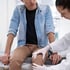 Doctor examining knee, preparing for trigger point injection therapy