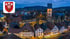 Luftaufnahme von Halle (Westf.) mit Fachwerkhäusern, St.-Johannis-Kirche bei Dämmerung und dem Stadtwappen oben links.