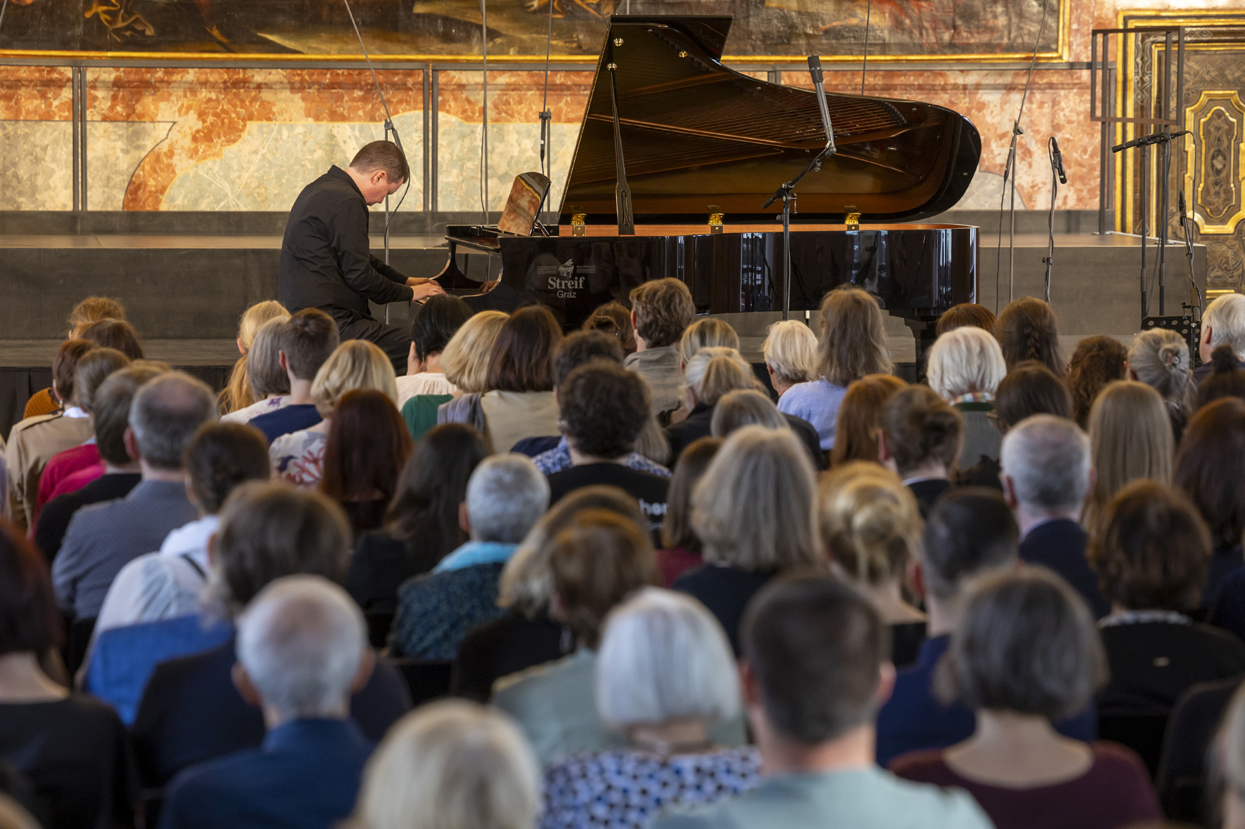 Artist in Residence Ola Gjeilo at the grand piano in the Minoritensaal, Voices of Spirit 2024, Graz