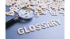 Lupe über dem Wort "GLOSSAR" und verstreuten Buchstaben