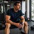 Muscular man in gym using Tesamorelin MGF Ipamorelin stack support.