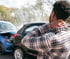 Man holding his neck after a car accident, suffering from whiplash