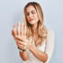 Woman experiencing wrist pain, carpal tunnel symptoms in clinic