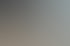 Drei lächelnde Kollegen sitzen an einem Konferenztisch und arbeiten gemeinsam an einem Laptop mit dem Logo Taxzero.