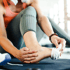 A person massaging their foot to relieve pain.
