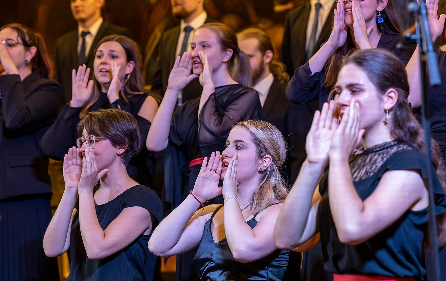 Singers of a choir calling out during a Voices of Spirit concert in Graz