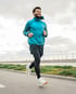 Runner outdoors managing back pain while staying active and moving