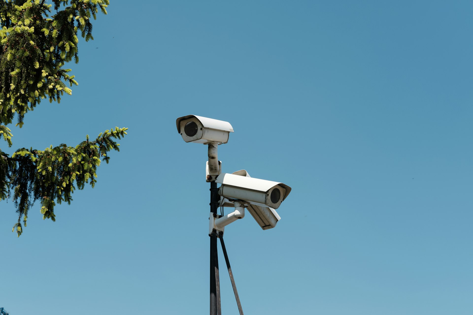 A dome security camera mounted under the eave of a San Mateo home