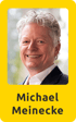 Michael Meinecke, lächelnder Mann mit grauen, lockigen Haaren und dunklem Anzug.