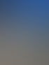 Klimaanlage auf einem schmutzigen Ziegeldach mit blauem Himmel.