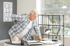 A man with back pain leans over a desk.
