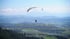 Gleitschirmflieger Markus Spenger schwebt über einem Tal mit Bergen und Text: "For me, life is continuously being hungry..."