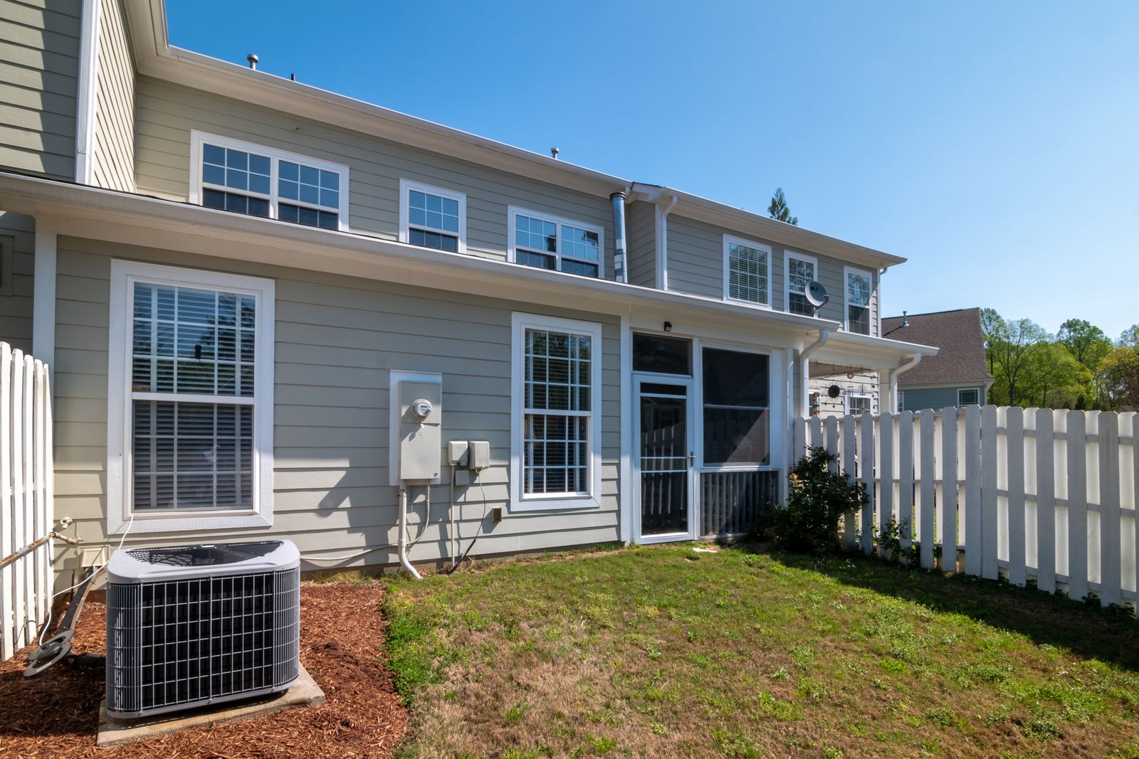 White vinyl fence beside a modern home