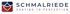 Logo Schmalriede mit Slogan "Coating to Perfection" und einem Symbol aus ineinandergreifenden Formen in Blau und Rot.