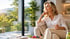 Woman relaxes with peptide therapy support in calm wellness setting.