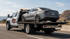 Towing Corona flatbed towing service transporting a sedan securely on a flatbed tow truck along the highway.