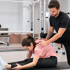Physical therapist assisting a woman with a rehabilitation session 








