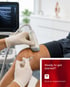 Gloved hands use ultrasound to guide an orthobiologic knee injection.