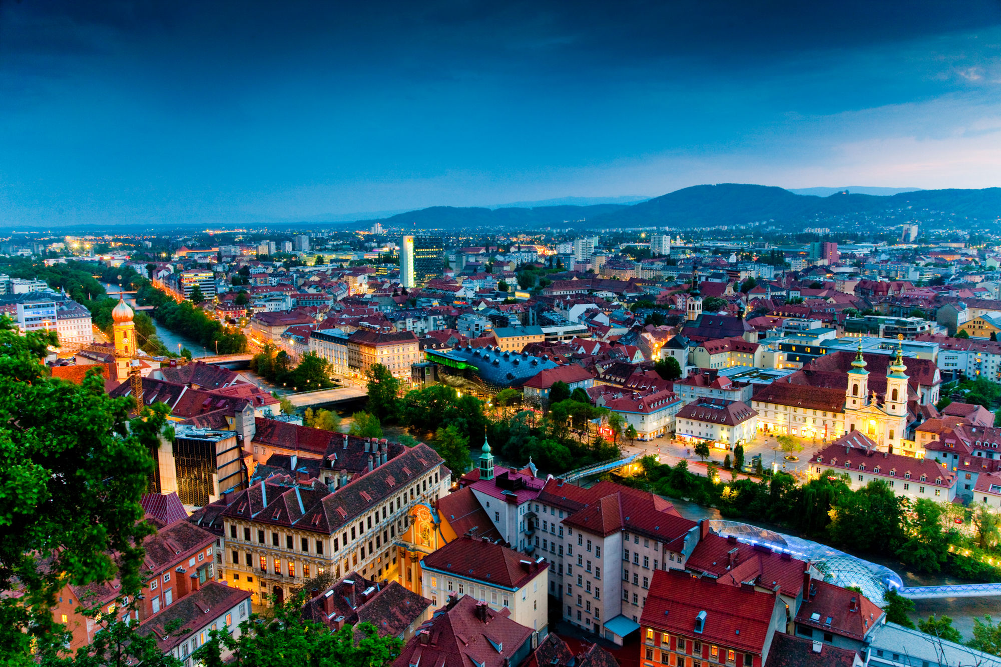 The old town of Graz at dusk with the clock tower above the city