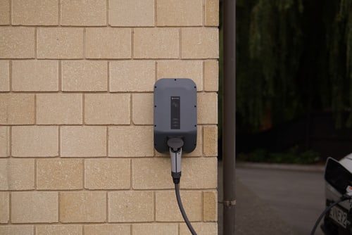EV charger mounted on a garage wall in a Fountain Valley home