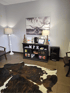 Cowhide rug on tile floor in a waiting room at Midwest Pain Relief Center, LLC.