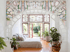 Art deco Bedroom with a wooden arch filled with stained-glass, a bed, and a stained-glass window above. French doors open to a garden.