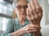 Older woman examining her painful hand — nerve pain evaluation at Accelerated Medical in Elko, NV