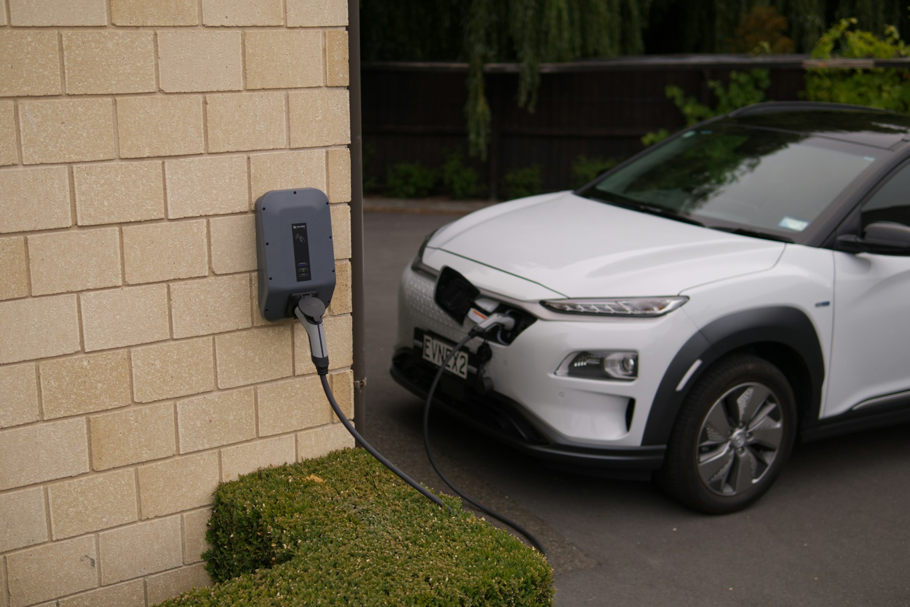 Electric vehicle parked in an assigned space at a multi-family community