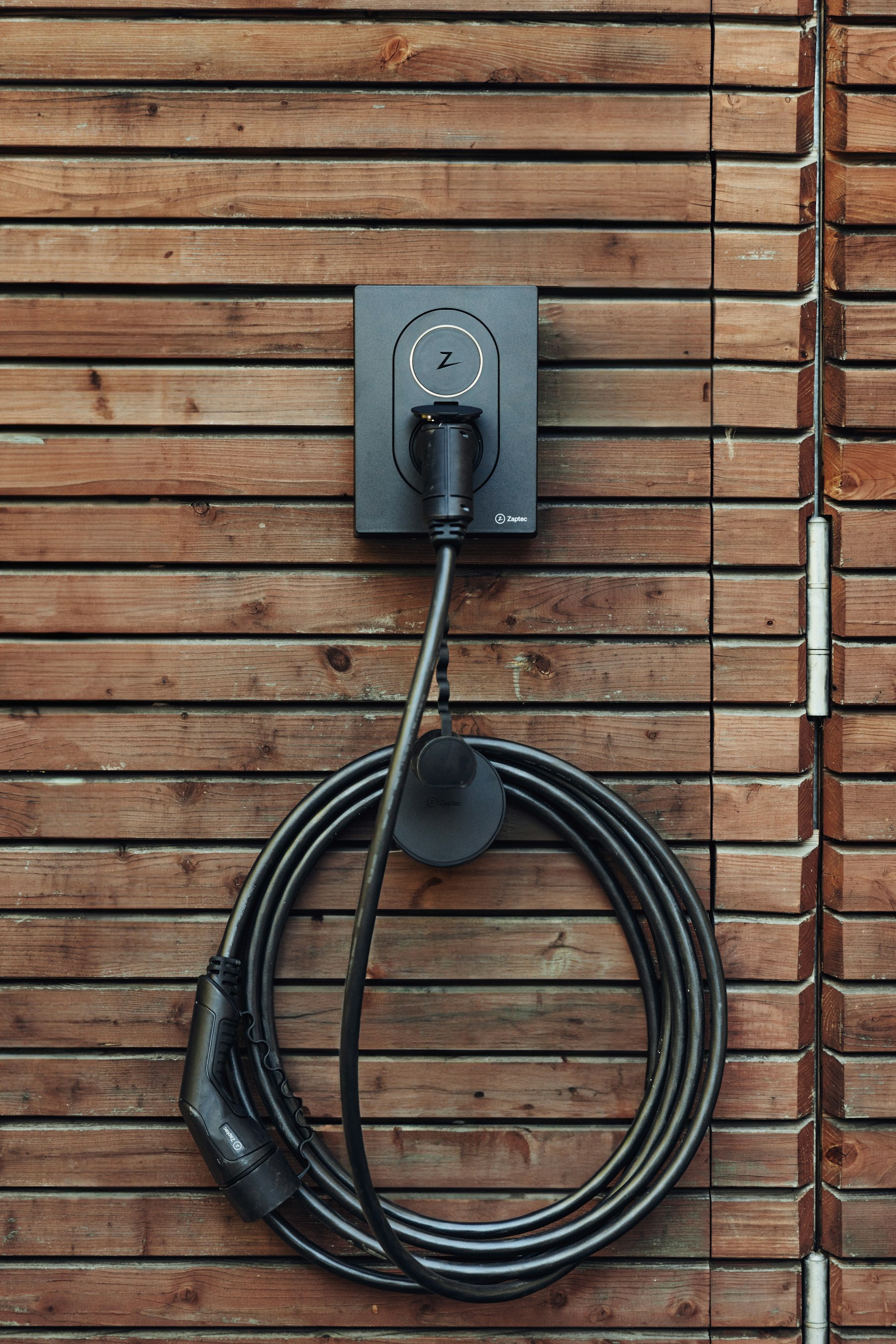 Level 2 EV charger cord mounted on a garage wall in Yorba Linda