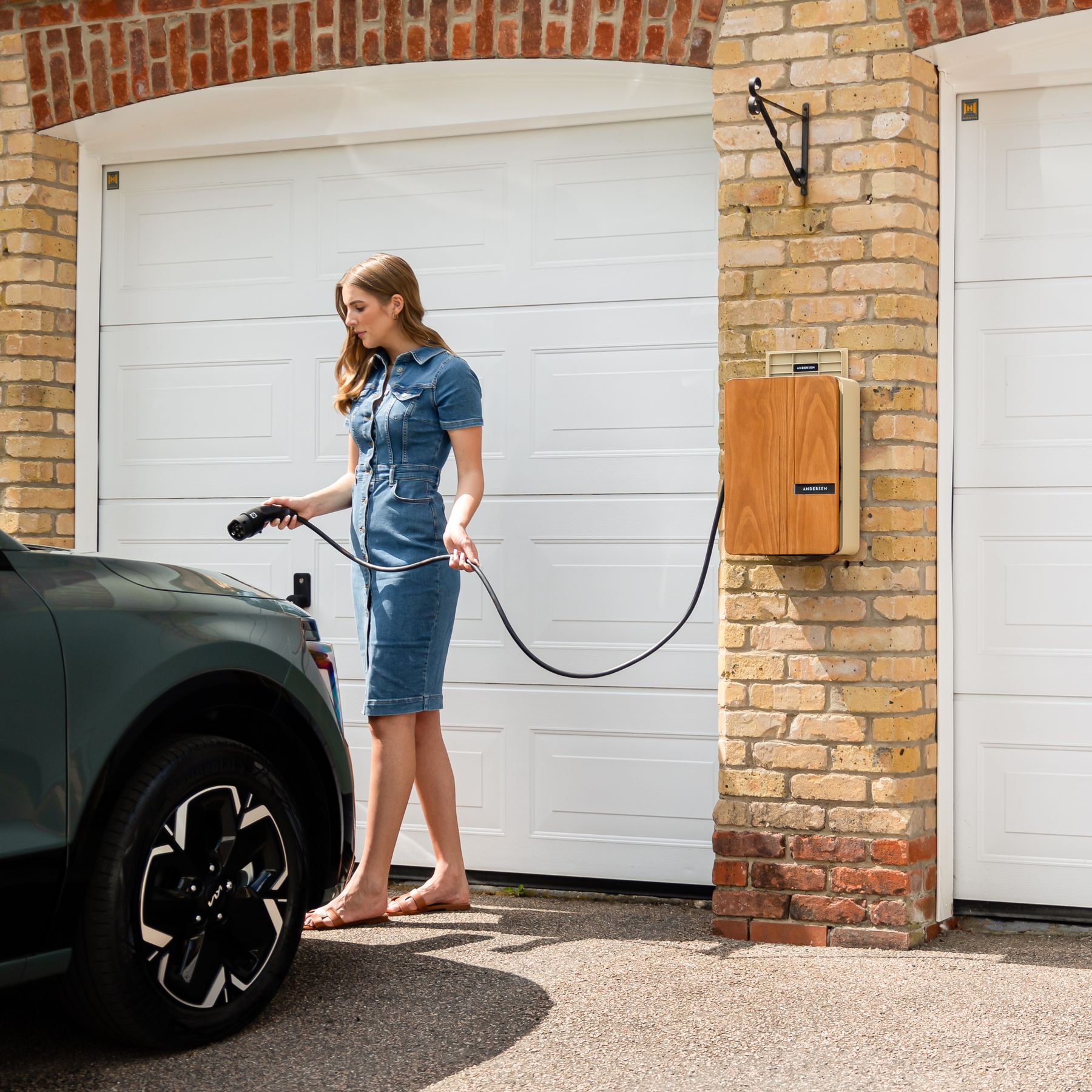 Wall-mounted home EV charger on a modern house exterior