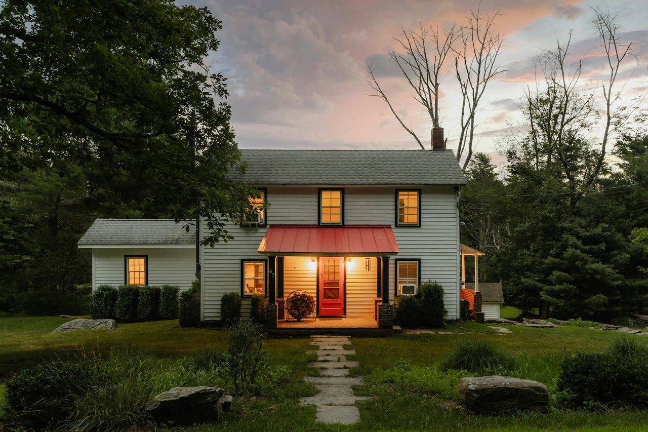 A Fishers, Indiana home lit at dusk with a covered front porch