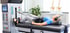 Woman lying on a spinal decompression table with leg and torso straps.