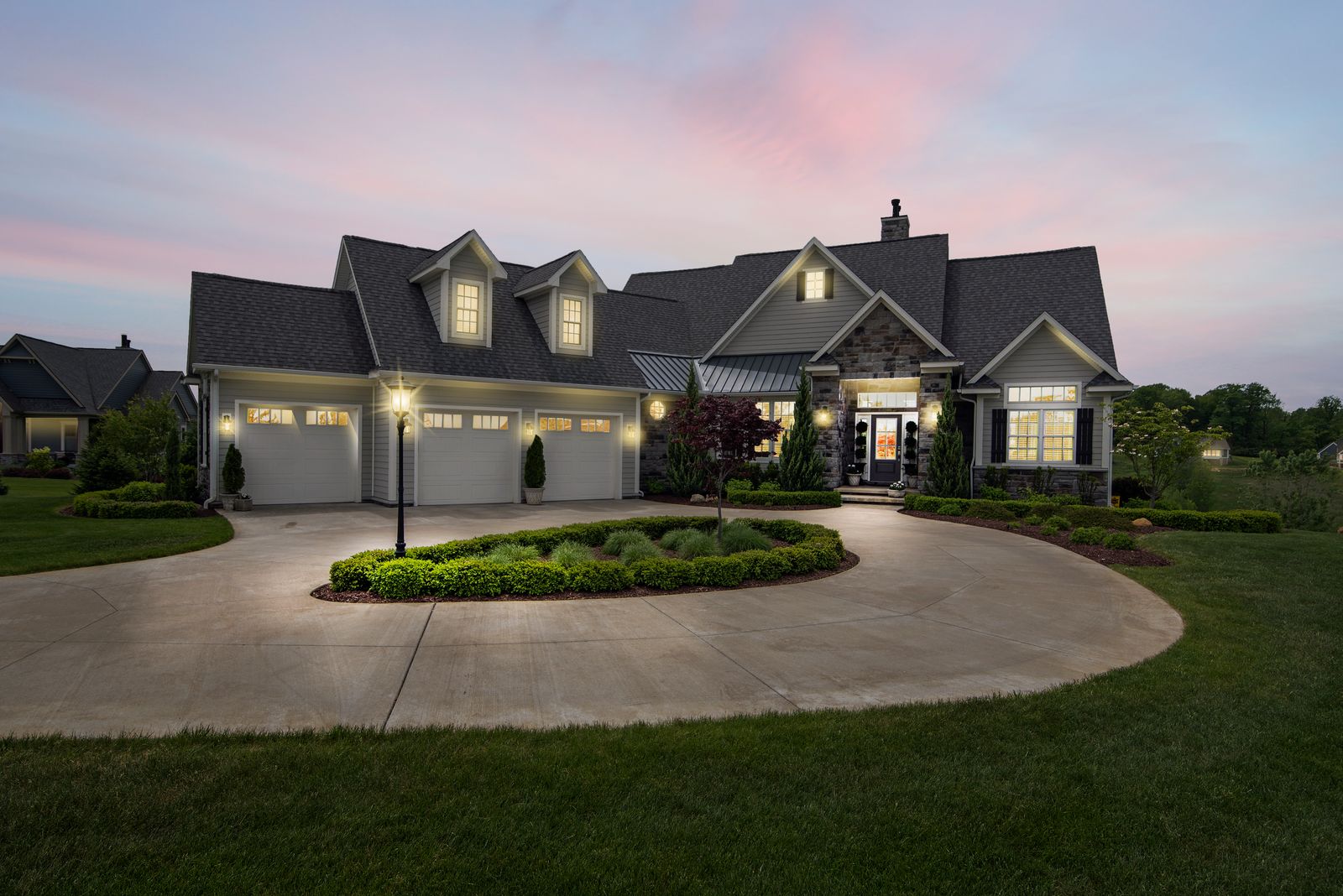 A Carmel, Indiana home at dusk with exterior lighting on