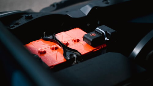 Car battery in an engine bay, where Florida heat shortens car battery life for drivers in Port Charlotte, FL