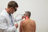 man getting laser therapy at Clayton Chiropractic