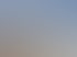 Baustelle mit Betonwänden und Holzdachkonstruktion unter blauem Himmel.