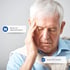 A man holds his head, experiencing pain or discomfort.