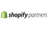 Shopify Partners Logo: grüne Einkaufstasche mit weißem „S“, daneben schwarzer Text „shopify partners“.