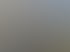 Mann mit Brille lächelt auf hohem Gerüst vor einer Landschaft mit Gebäuden.