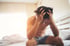 Man sitting on bed with head in hands