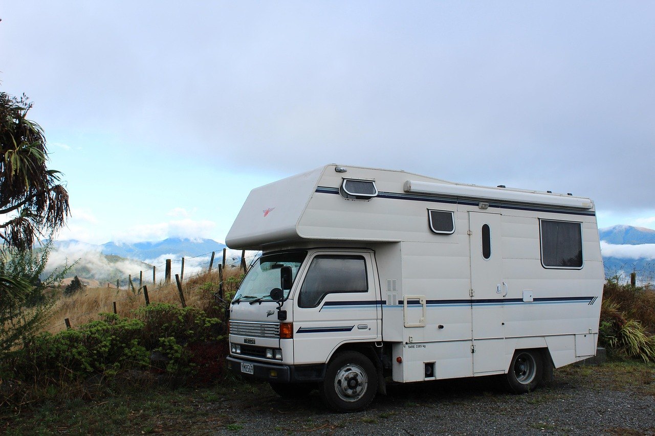 A Class A motorhome on the open road, the kind of RV that needs a heavy-duty tow when it stops on US 441 or State Road 19 near Tavares, FL.